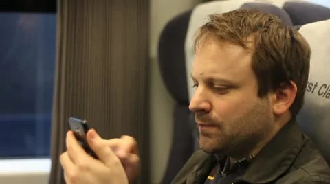 Using smart phone on train Stock Footage 20631348
