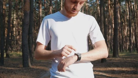 Using smart watch at jogging exercise in the forest Video stock 111699487