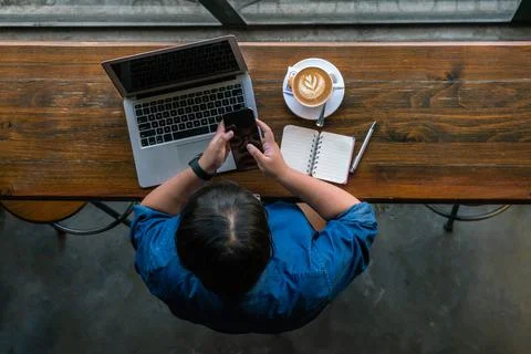Using smartphone and laptop Stock Photos
