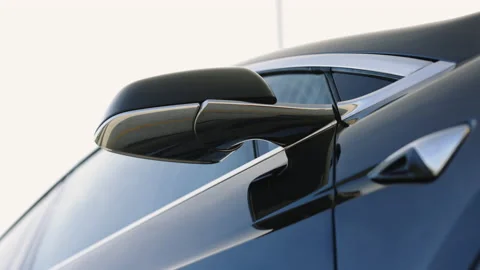 Using smartphone app for remote controlling of black premium class electric car Stock Footage 220321785