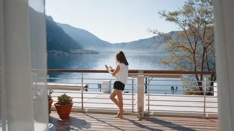 Using smartphone on the balcony 動画素材 116304983