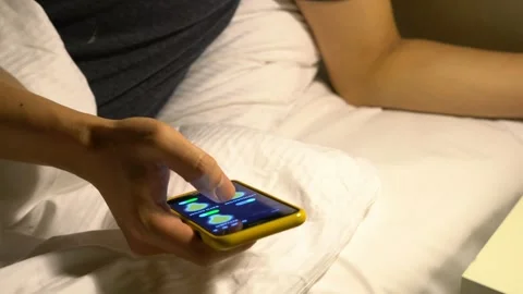 Using a Smartphone in Bed for Relaxation Stock Footage 314611755