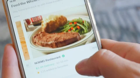 Using Smartphone Buying in Internet Shop Ordering meal Online Store POV Stock Footage 128880066