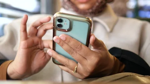 Using a smartphone in a cafe during the day Stock Footage 344723551
