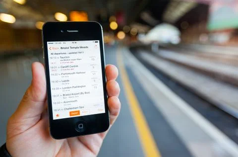 Using a smartphone to check train times and platforms Stock Photos