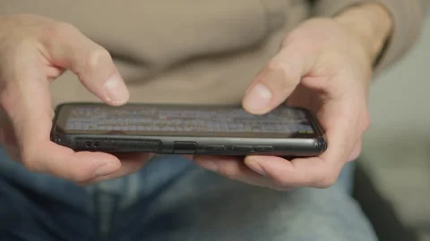 Using a smartphone close-up: a man's hands use the device to access mobile Video stock 240840942