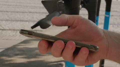 Using smartphone for contactless payment of electric scooter Stock Footage 115084227