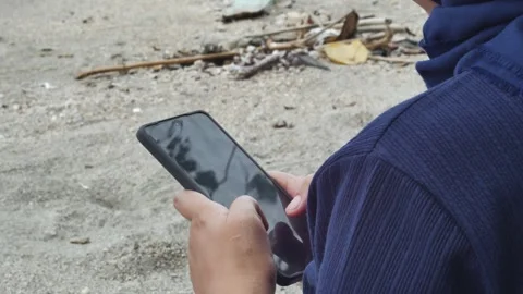 Using smartphone device on beach. Stock-Footage 294352439
