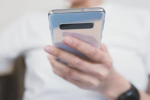 Using a smartphone for everyday purposes. Close-up on the phone in hand Stock Photos