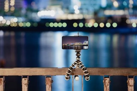 Using smartphone on flexible tripod to making the photo of city night lights Stock Photos