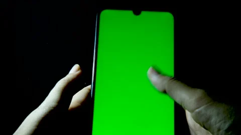 Using smartphone with green screen on mobile phone. scrolling up. black Video stock 131299782