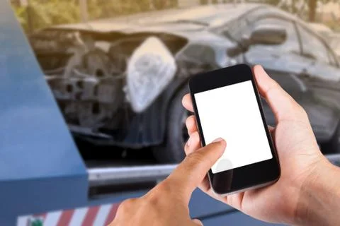 Using smartphone on hand with blurry background of black car on accident on t Stock Photos