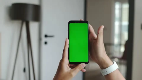 Using Smartphone in Horizontal Mode with Green Mock-up Screen. Luma Colour Stock Footage 195093774