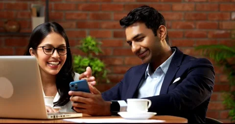 Using smartphone in office break, Indian coworkers scrolling social media Stock-Footage 342595641