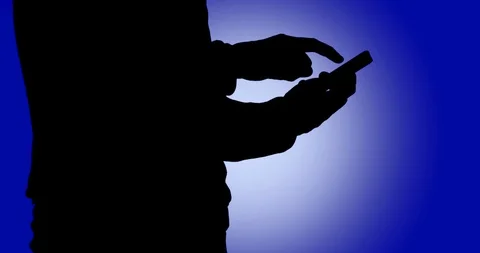 Using a smartphone in privacy as user is in silhouette and anonymous Vídeo Stock 111426877