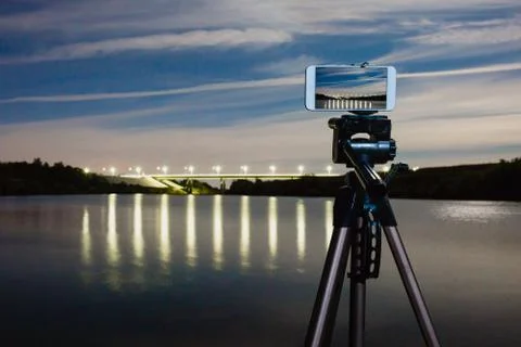 Using smartphone like professional camera on tripod to capturing night landscape Stock Photos