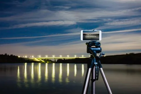 Using smartphone like professional camera on tripod to capturing night landscape Stock Photos