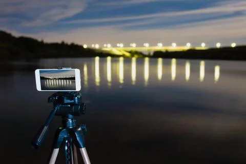 Using smartphone like professional camera on tripod to capturing night landscape Stock Photos