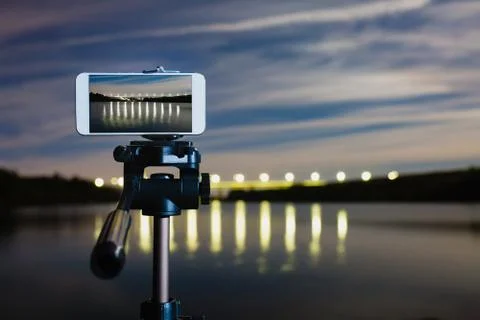 Using smartphone like professional camera on tripod to capturing night landscape Stock Photos