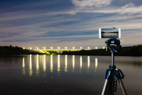 Using smartphone like professional camera on tripod to capturing night landscape Stock Photos