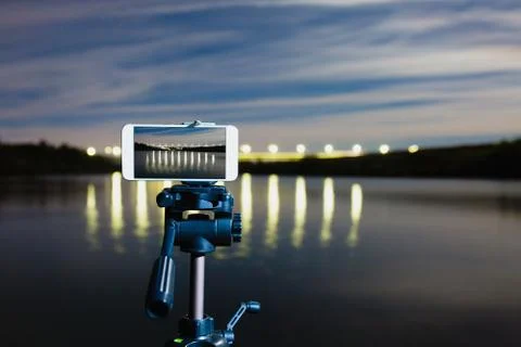 Using smartphone like professional camera on tripod to capturing night landscape Stock Photos