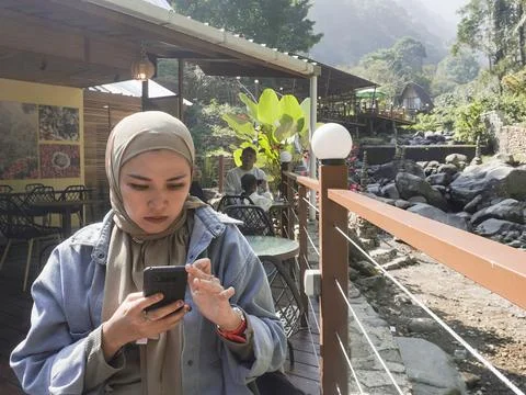 Using smartphone relaxed at outdoor Stock Photos