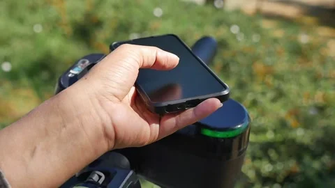Using a smartphone to scan the Qr code of the electric scooter outdoor Stock Footage 340442870