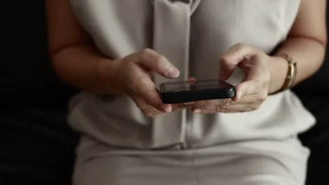Using smartphone on sofa Stock Footage 310864879