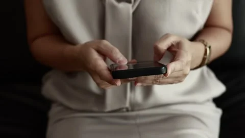 Using smartphone on sofa Stock Footage 310864885