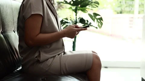 Using smartphone on sofa Stock Footage 310864886