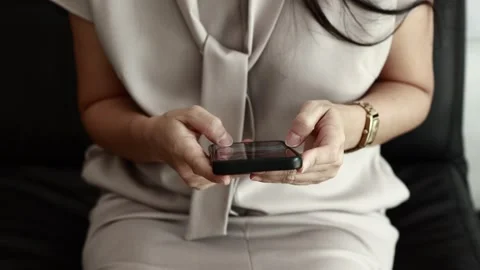 Using smartphone on sofa Stock Footage 310864888