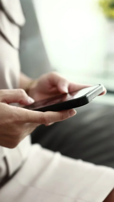 Using smartphone on sofa Stock Footage 310864889