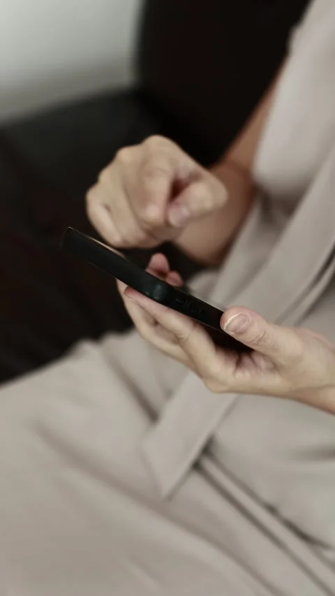 Using smartphone on sofa Stock Footage 310864907