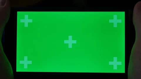 Using a smartphone tablet in a dark room green screen Stock Footage 90907521