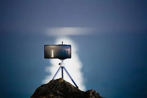 Using smartphone on tripod to making the photo with beautiful moon road Stock Photos