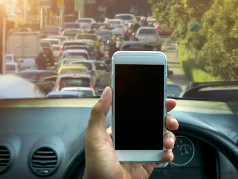 Using a smartphone while driving a car Foto stock