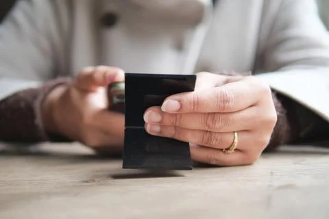 Using a smartphone while holding a  QR code to find the menu in hands Stock Photos