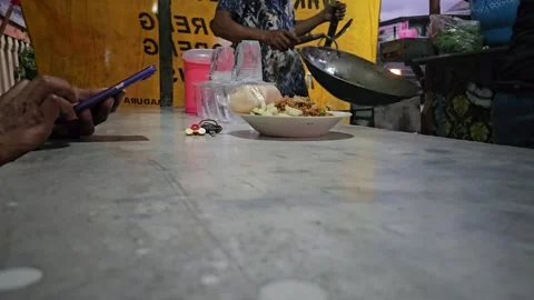 Using Smartphone While Waiting at Indonesian Street Food Stall Vídeos de archivo 332196450