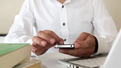 Using Smartphone While Working at Office Desk Stock Footage 346183497