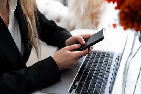 Using smartphone at work desk, social and business apps 스톡 사진