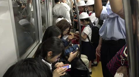 Using smartphones on Tokyo metro commute Stock Footage 39722065