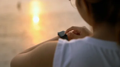 Using smartwatch at sunset slowmotion Stock Footage 123513676