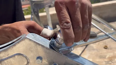 Using a Socket Wrench on a Metal Frame Stock Footage 345208242