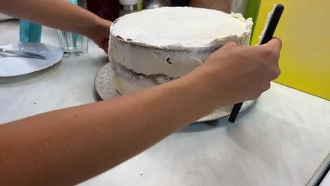 Using a spatula to frost the cake with sugar icing Stock Footage 268395115
