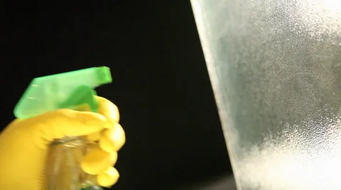 Using spray cleaner to wash glass window Stock Footage 37227173
