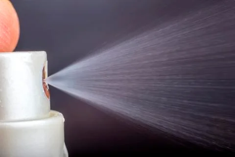 Using a spray Stock Photos