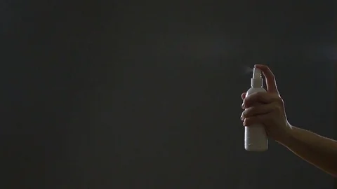 Using Spraying Bottle in Gray Background Studio, Slow Motion Video stock 76523080