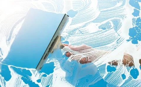 Using a squeegee to clear the blue sky above Photos