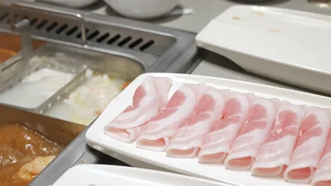 Using stainless chopsticks pick fine cutting pork meat sliced from tray Stock Footage 218360969