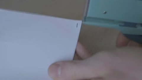 Using a stapler to staple some papers in the office Stock Footage 169287036